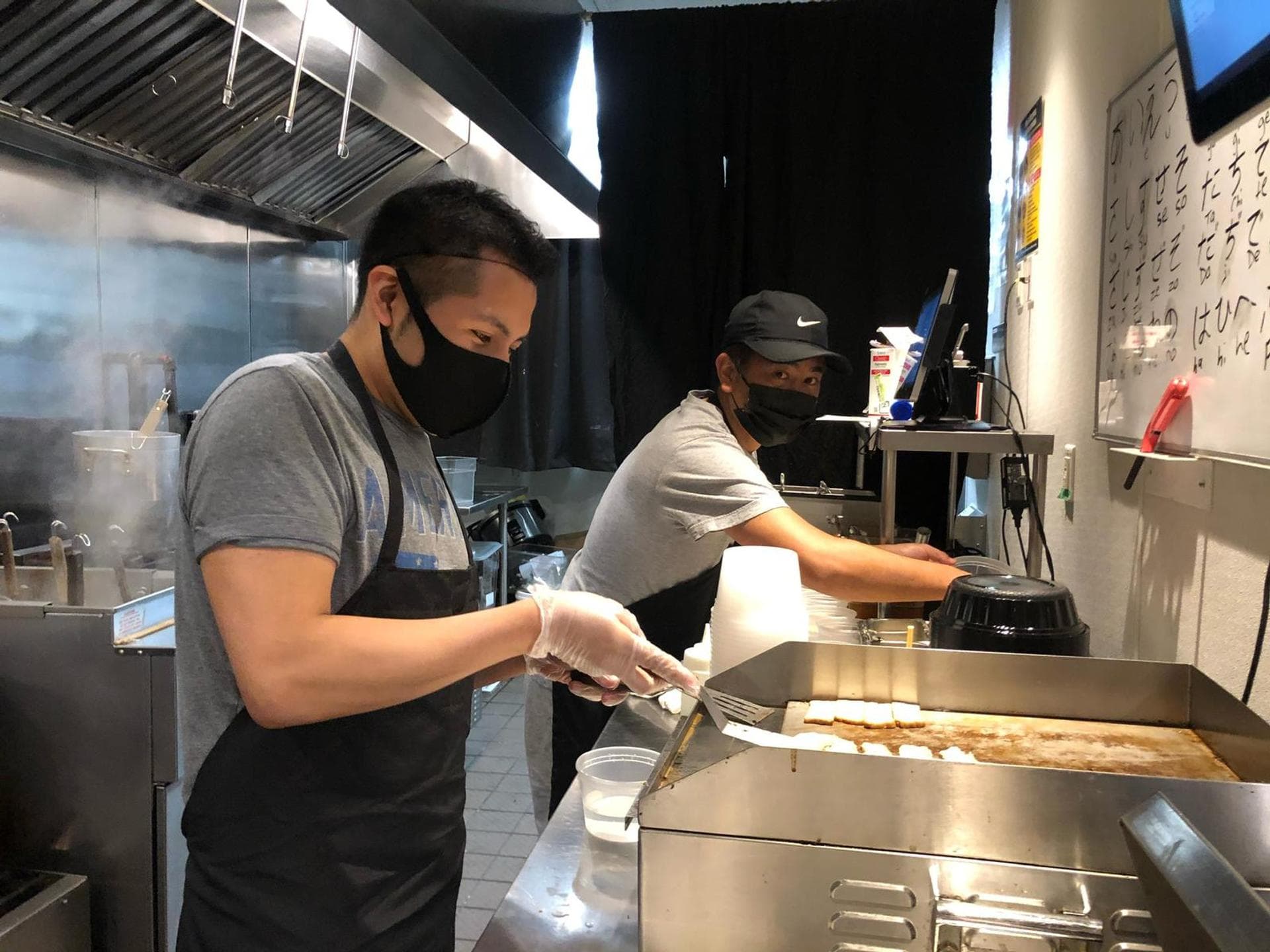 Tatsu Ramen team members behind the counter